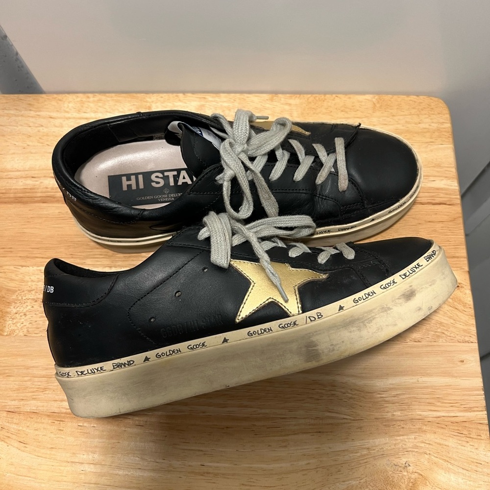 Authentic Golden Goose Hi Star Leather Sneakers black with gold star.
Size 7.